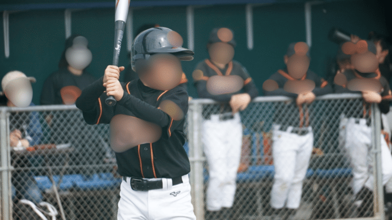 緊張した表情で初打席に立つ少年野球の5年生の選手